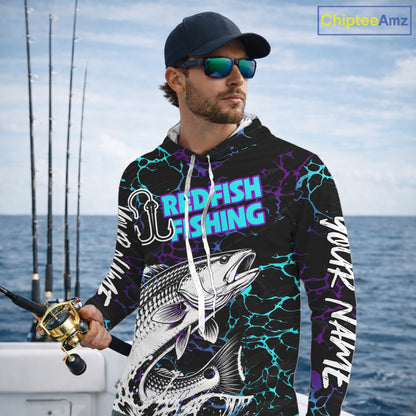 Angler wearing Redfish Fishing neon blue long sleeve hooded saltwater fishing shirt on the boat