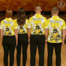 Load image into Gallery viewer, Back view of bowling team wearing matching yellow banana bowling shirts in a bowling alley.