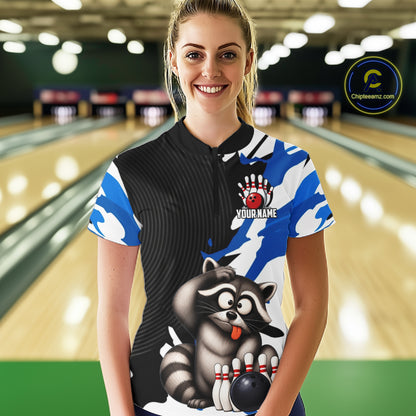 Woman wearing a bowling shirt with a raccoon design in a bowling alley.