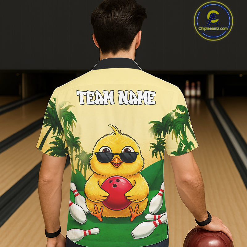 Person wearing a shirt with a cartoon duck holding a bowling ball and text 'TEAM NAME' in a bowling alley.