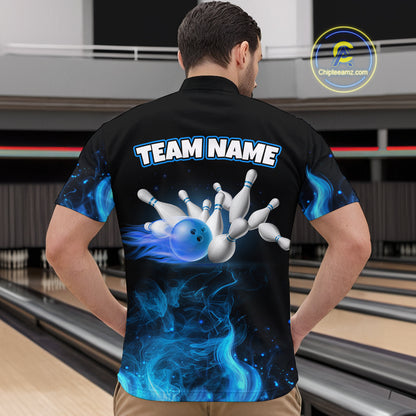 Person wearing a black bowling shirt with a blue and white design of a bowling ball and pins, standing in a bowling alley.